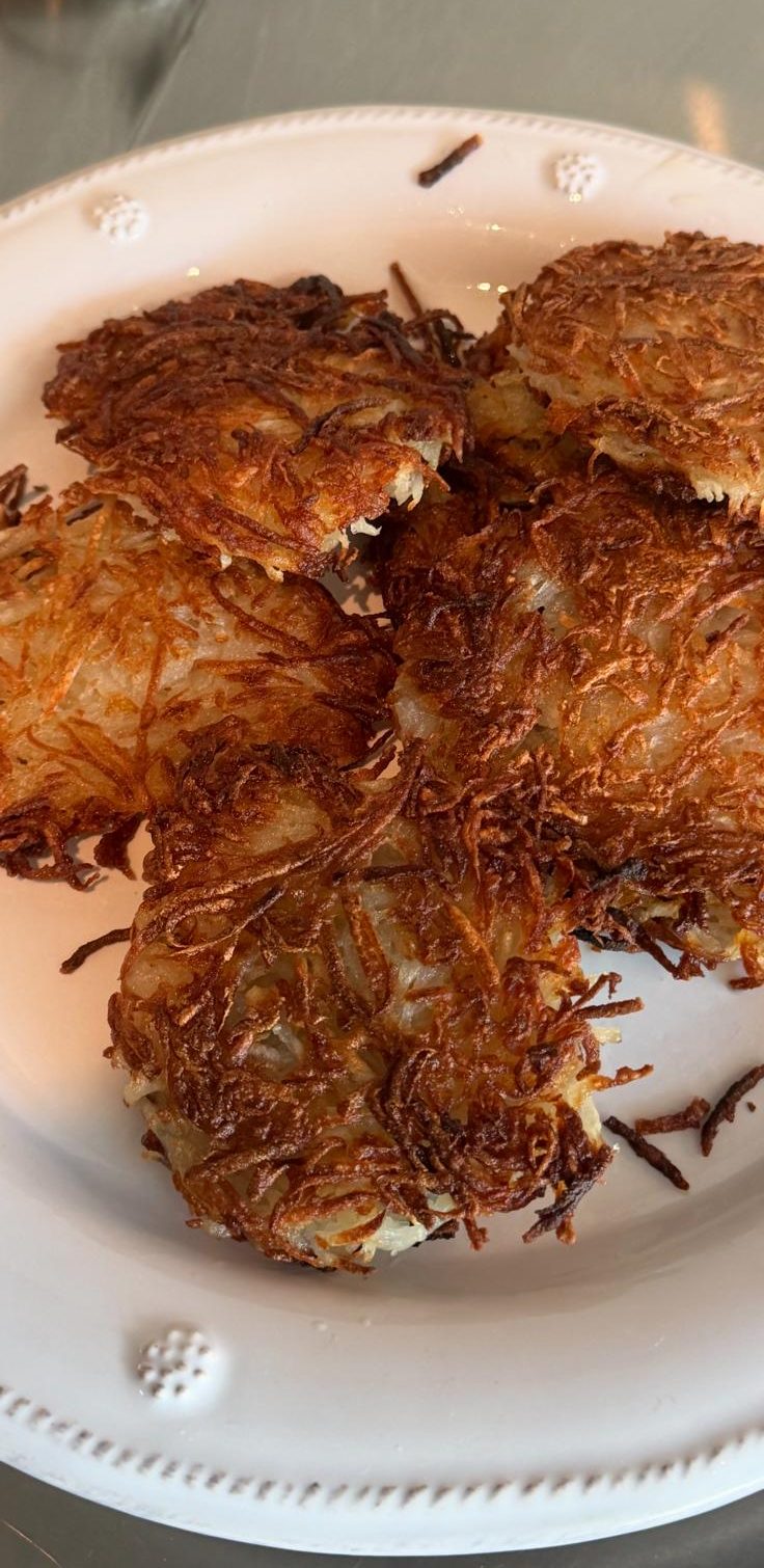 Crisp shredded hash browns, deep golden and crackling, on a plate.